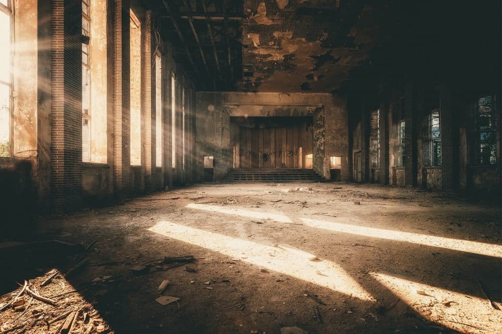 Vacant building with boarded windows and a security notice