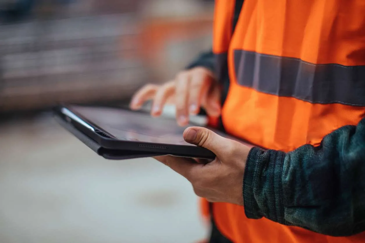 Inspector reviewing property condition report on tablet